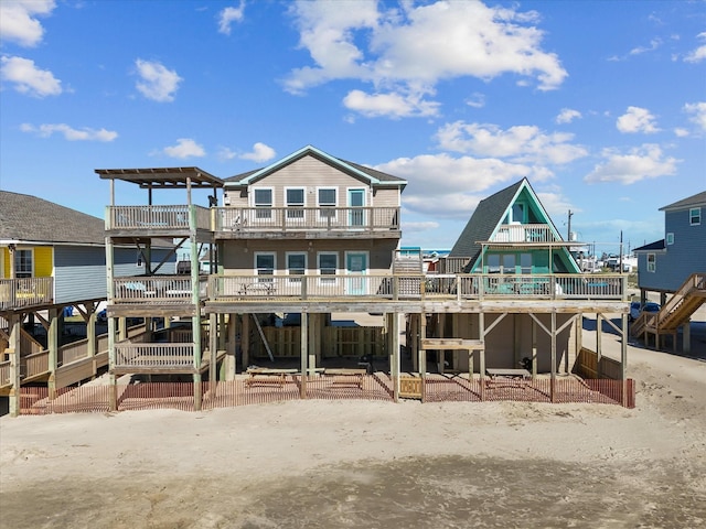 back of property with a wooden deck and stairs