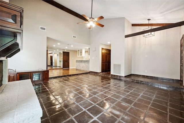 unfurnished living room featuring high vaulted ceiling, ceiling fan, baseboards, and visible vents