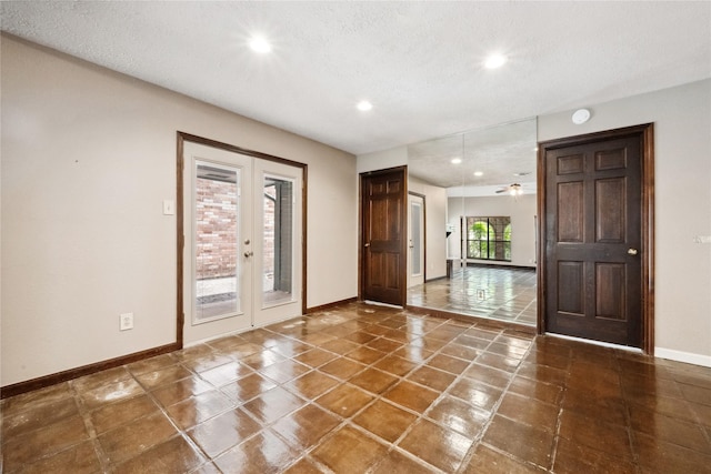 entrance foyer with tile patterned flooring, baseboards, recessed lighting, a textured ceiling, and french doors