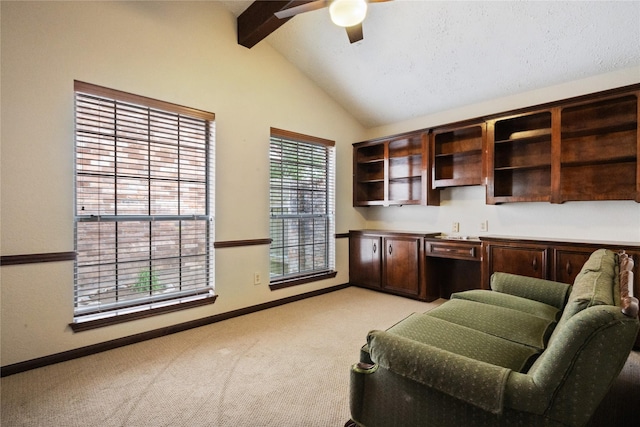 office area with lofted ceiling with beams, baseboards, light carpet, and a ceiling fan
