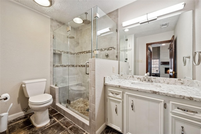 full bath with vanity, toilet, baseboards, a shower stall, and visible vents