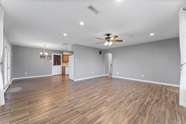 10 Hillcrest St, Point Blank, TX 77364 - unfurnished living room featuring dark wood finished floors, visible vents, baseboards, and ceiling fan with notable chandelier