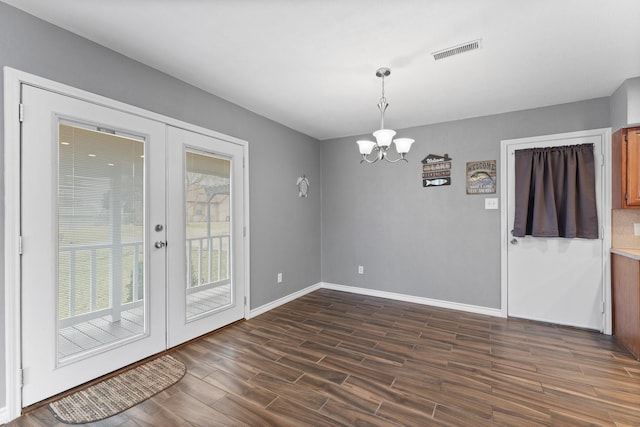 10 Hillcrest St, Point Blank, TX 77364 - unfurnished dining area featuring french doors, dark wood finished floors, baseboards, visible vents, and a chandelier