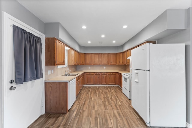 10 Hillcrest St, Point Blank, TX 77364 - kitchen with recessed lighting, light countertops, a sink, white appliances, and light wood-type flooring