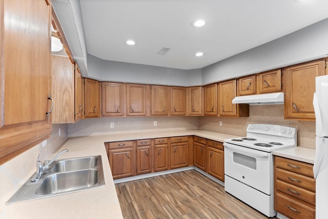 10 Hillcrest St, Point Blank, TX 77364 - kitchen featuring brown cabinets, under cabinet range hood, a sink, and white appliances