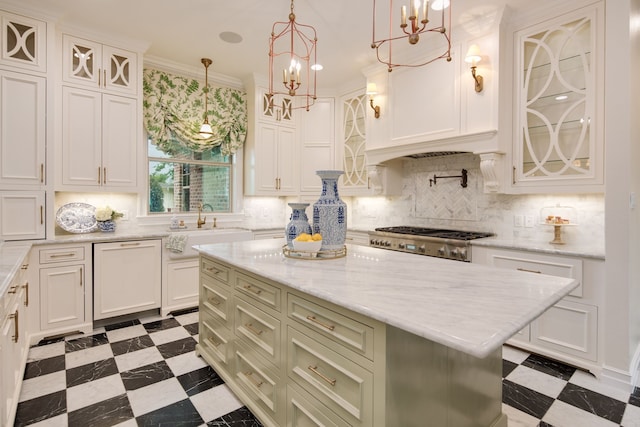 kitchen with stainless steel gas cooktop, tile patterned floors, paneled dishwasher, and a sink