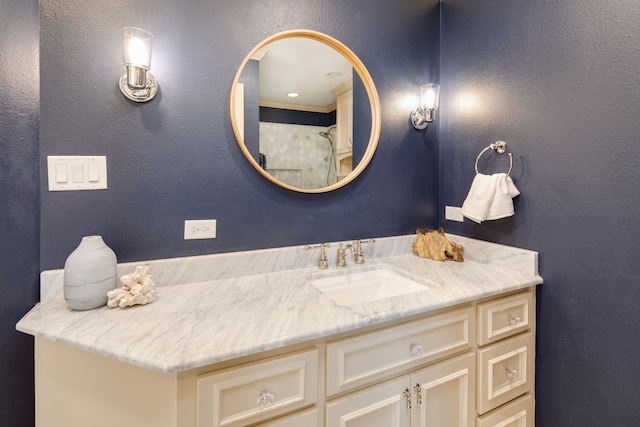 bathroom featuring a textured wall and vanity