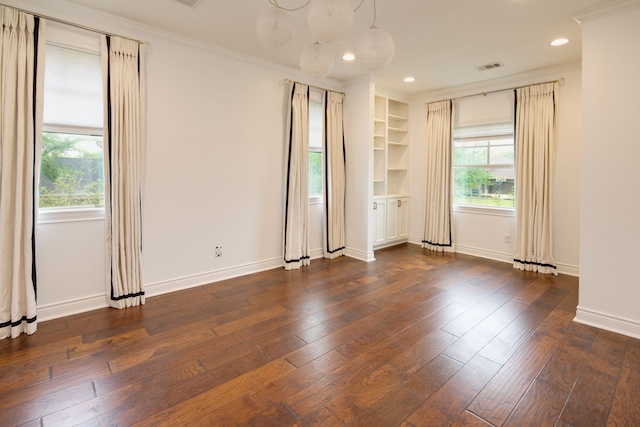 unfurnished room with dark wood finished floors, baseboards, crown molding, and plenty of natural light