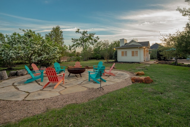 view of jungle gym featuring a fire pit, a patio area, fence, and a yard