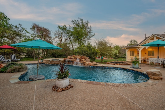 view of pool featuring a patio and a pool with connected hot tub