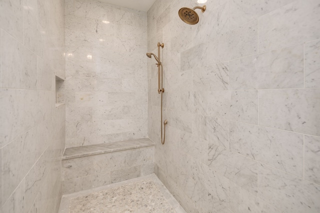 interior details with a tile shower