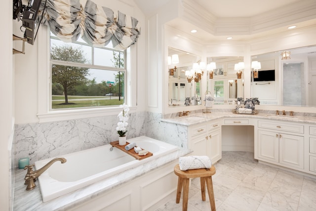 full bathroom with plenty of natural light, a garden tub, marble finish floor, and vanity