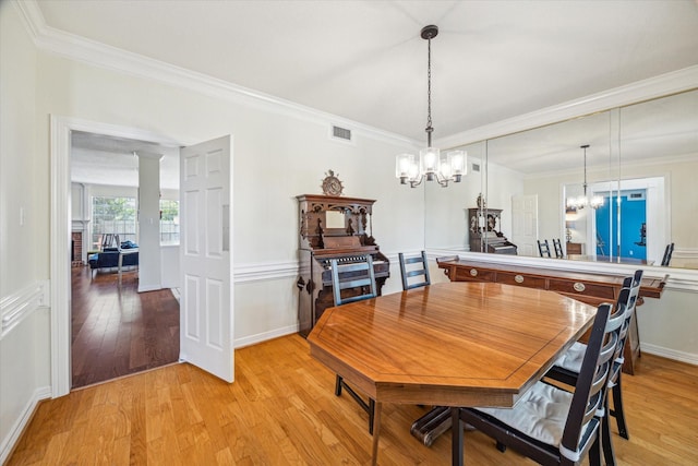7930 Tizerton Ct, Spring, TX 77379 - dining area featuring a chandelier, light wood-style flooring, and ornamental molding