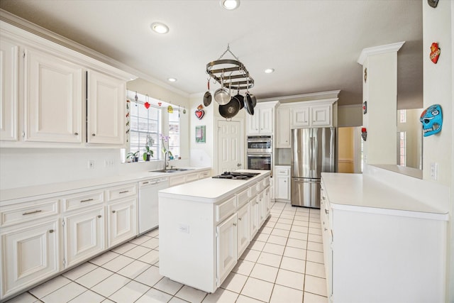 7930 Tizerton Ct, Spring, TX 77379 - kitchen with appliances with stainless steel finishes, a sink, light countertops, a kitchen island, and light tile patterned floors
