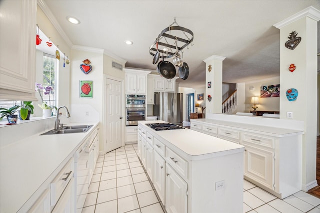 7930 Tizerton Ct, Spring, TX 77379 - kitchen featuring stainless steel appliances, a sink, a center island, light tile patterned flooring, and recessed lighting
