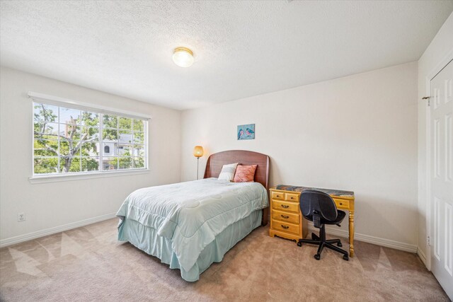 7930 Tizerton Ct, Spring, TX 77379 - bedroom with light colored carpet, baseboards, and a textured ceiling