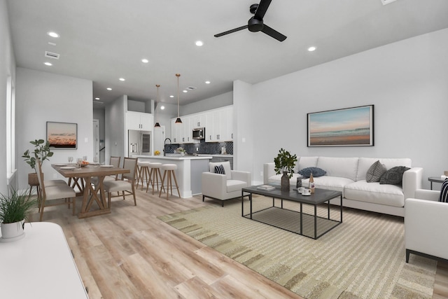 6817 Peerless St, Houston, TX 77021 - living area featuring recessed lighting, visible vents, light wood finished floors, and ceiling fan