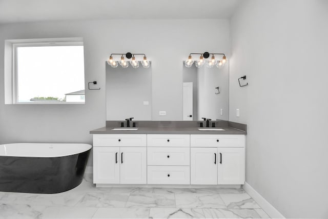 6817 Peerless St, Houston, TX 77021 - full bath featuring marble finish floor, a freestanding bath, a sink, and double vanity