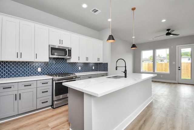 6817 Peerless St, Houston, TX 77021 - kitchen featuring light stone counters, stainless steel appliances, visible vents, and a sink