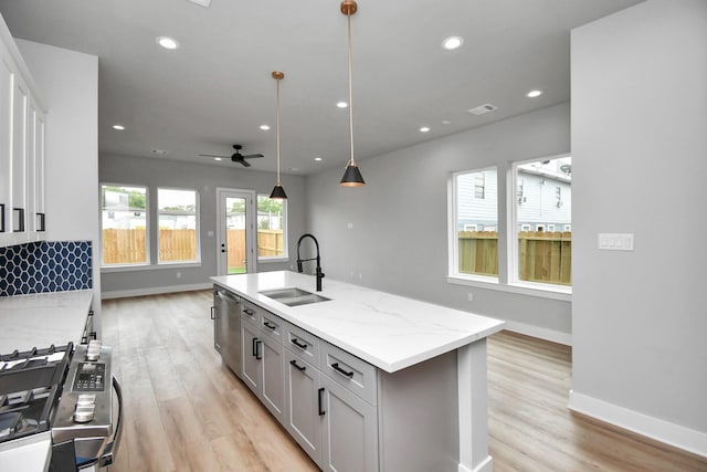 6817 Peerless St, Houston, TX 77021 - kitchen featuring ceiling fan, light wood-type flooring, stainless steel appliances, and a sink