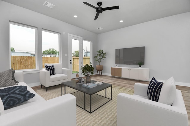 6817 Peerless St, Houston, TX 77021 - living area featuring baseboards, a ceiling fan, visible vents, and light wood-style flooring