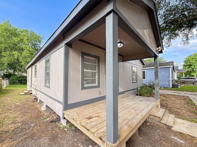 view of property exterior with a deck