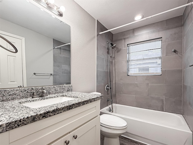 bathroom with shower / bathtub combination, toilet, vanity, and wood finished floors
