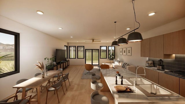 2105 Holman St, Houston, TX 77004 - kitchen with open floor plan, backsplash, light wood-style floors, modern cabinets, and black electric stovetop