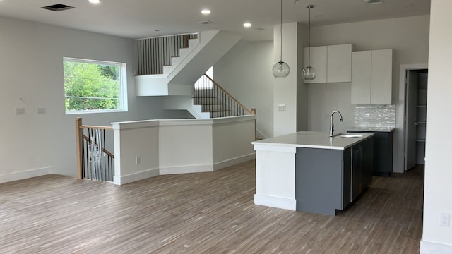 2105 Holman St, Houston, TX 77004 - kitchen featuring visible vents, a sink, a center island with sink, light wood-style flooring, and open floor plan