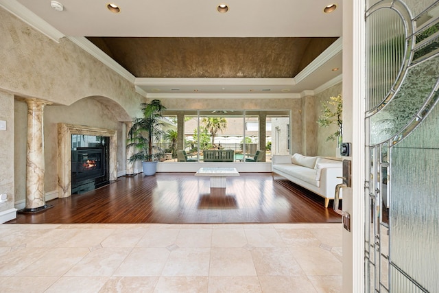 unfurnished living room with crown molding, wood finished floors, and a fireplace