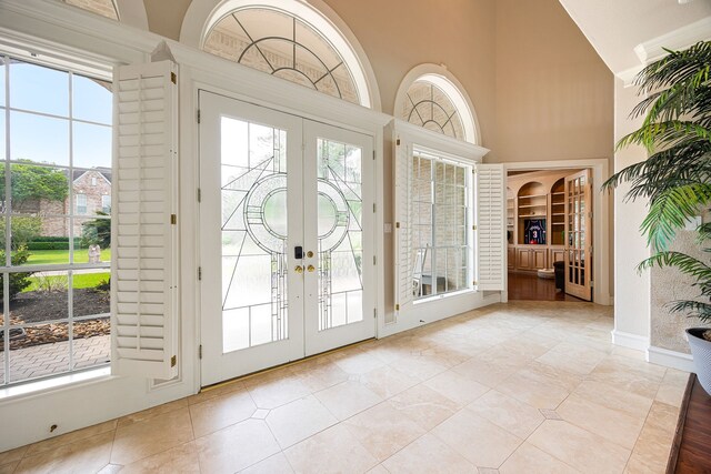 13602 Copeland Oaks Blvd, Cypress, TX 77429 - foyer featuring french doors, high vaulted ceiling, and light tile patterned flooring