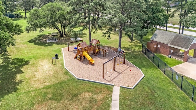 view of home's community featuring a yard, a playground, and fence