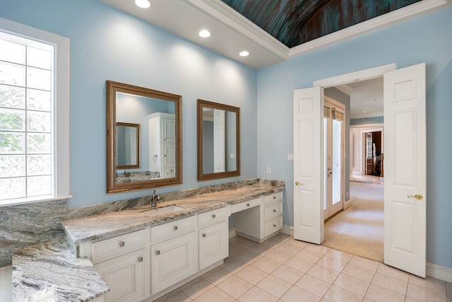 bathroom featuring recessed lighting, tile patterned floors, double vanity, a sink, and baseboards