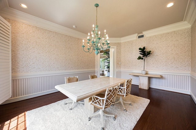 dining space with wood finished floors, visible vents, a wainscoted wall, and a notable chandelier
