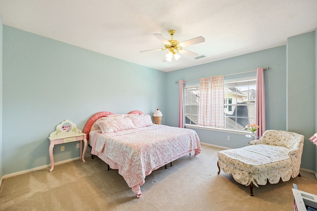 carpeted bedroom with ceiling fan, baseboards, and visible vents