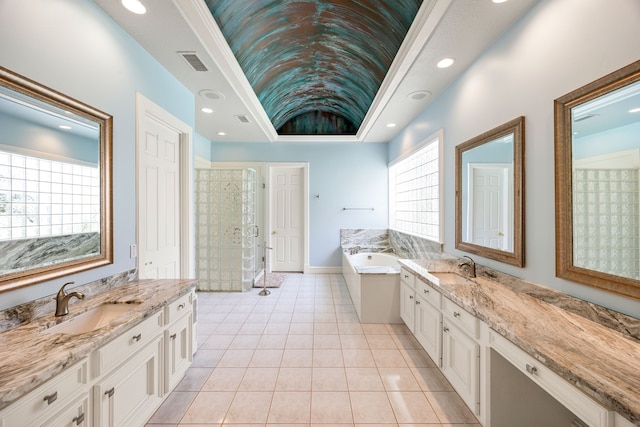 full bathroom with tile patterned flooring, visible vents, a sink, two vanities, and a stall shower