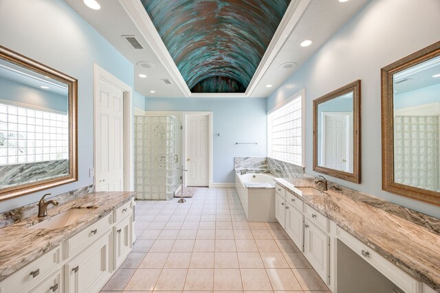 13602 Copeland Oaks Blvd, Cypress, TX 77429 - bathroom featuring two vanities, a garden tub, a stall shower, tile patterned flooring, and recessed lighting