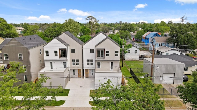 rear view of house featuring fence and a residential view