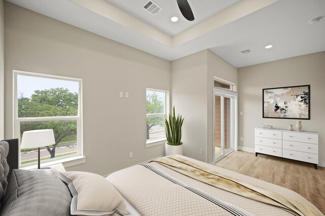 bedroom with light wood finished floors, multiple windows, visible vents, and recessed lighting