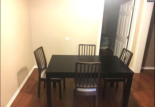 dining room with baseboards and wood finished floors