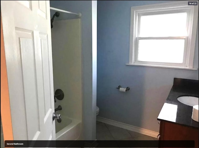 full bathroom with tile patterned floors, toilet, vanity, baseboards, and shower / bathing tub combination