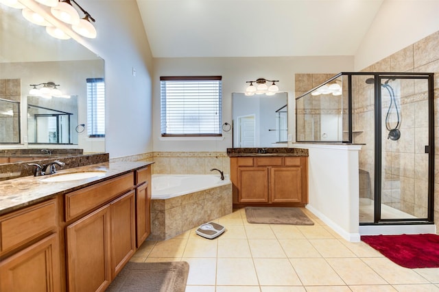 5002 Sawmill Terrace Ln, Spring, TX 77389 - bathroom featuring lofted ceiling, a shower stall, tile patterned flooring, a bath, and two vanities