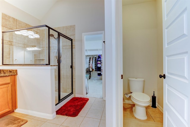 5002 Sawmill Terrace Ln, Spring, TX 77389 - bathroom featuring a shower stall, a spacious closet, tile patterned flooring, and vaulted ceiling
