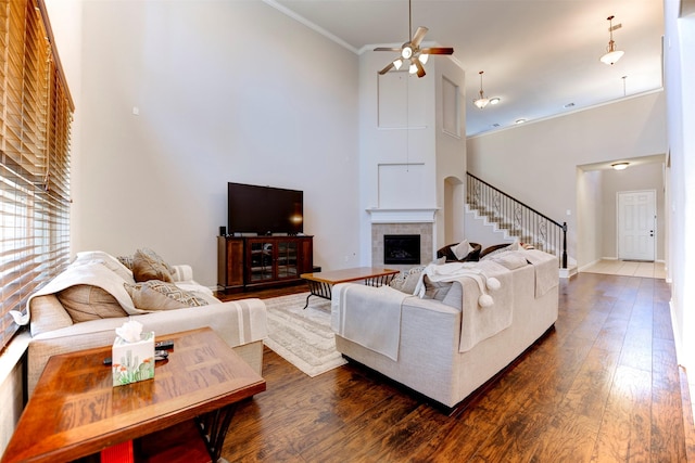 5002 Sawmill Terrace Ln, Spring, TX 77389 - living area featuring a high ceiling, ceiling fan, dark wood-type flooring, stairway, and ornamental molding