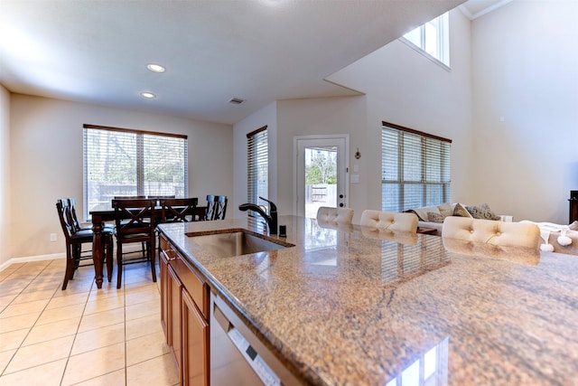 5002 Sawmill Terrace Ln, Spring, TX 77389 - kitchen featuring a sink, light tile patterned floors, plenty of natural light, brown cabinets, and recessed lighting