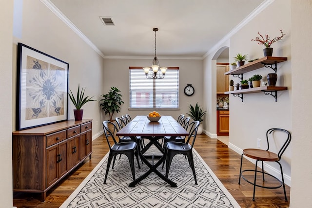 5002 Sawmill Terrace Ln, Spring, TX 77389 - dining space with a chandelier, dark wood finished floors, arched walkways, ornamental molding, and baseboards