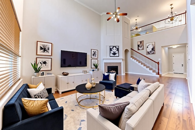 5002 Sawmill Terrace Ln, Spring, TX 77389 - living area with a towering ceiling, light wood-style floors, a chandelier, stairway, and a ceiling fan