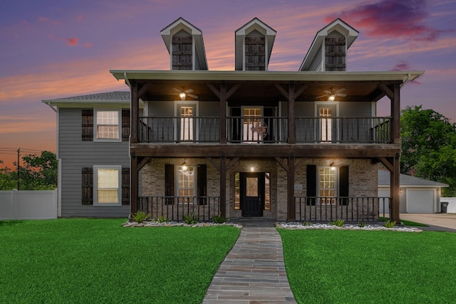 view of front of property with a yard, covered porch, and a balcony