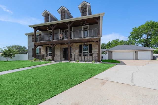 view of front facade featuring a ceiling fan, a balcony, a front yard, and a detached garage
