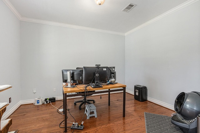 office space featuring wood finished floors, visible vents, crown molding, and baseboards